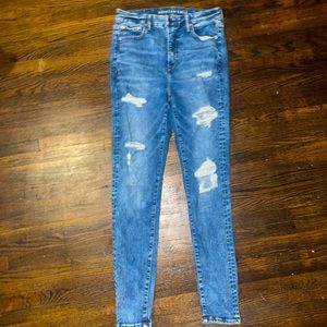 Medium acid wash AE luxe jeans size 10R, GUC, larger hole on left knee